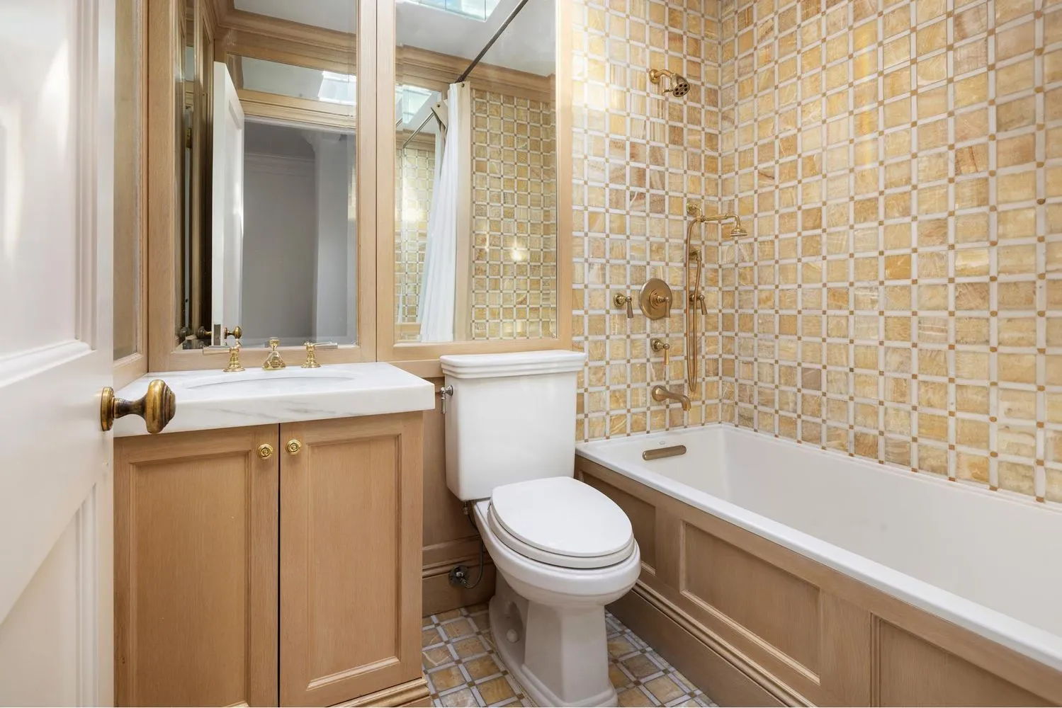 a bathroom with a granite countertop toilet a sink and a bathtub