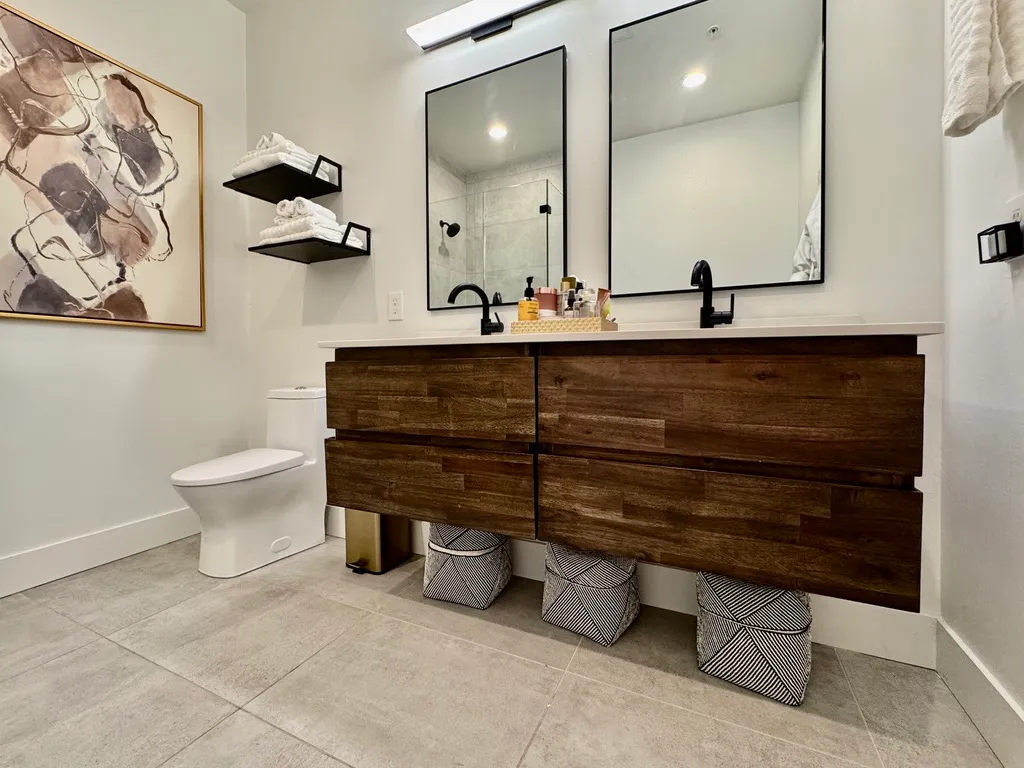 a bathroom with a toilet a sink and mirror