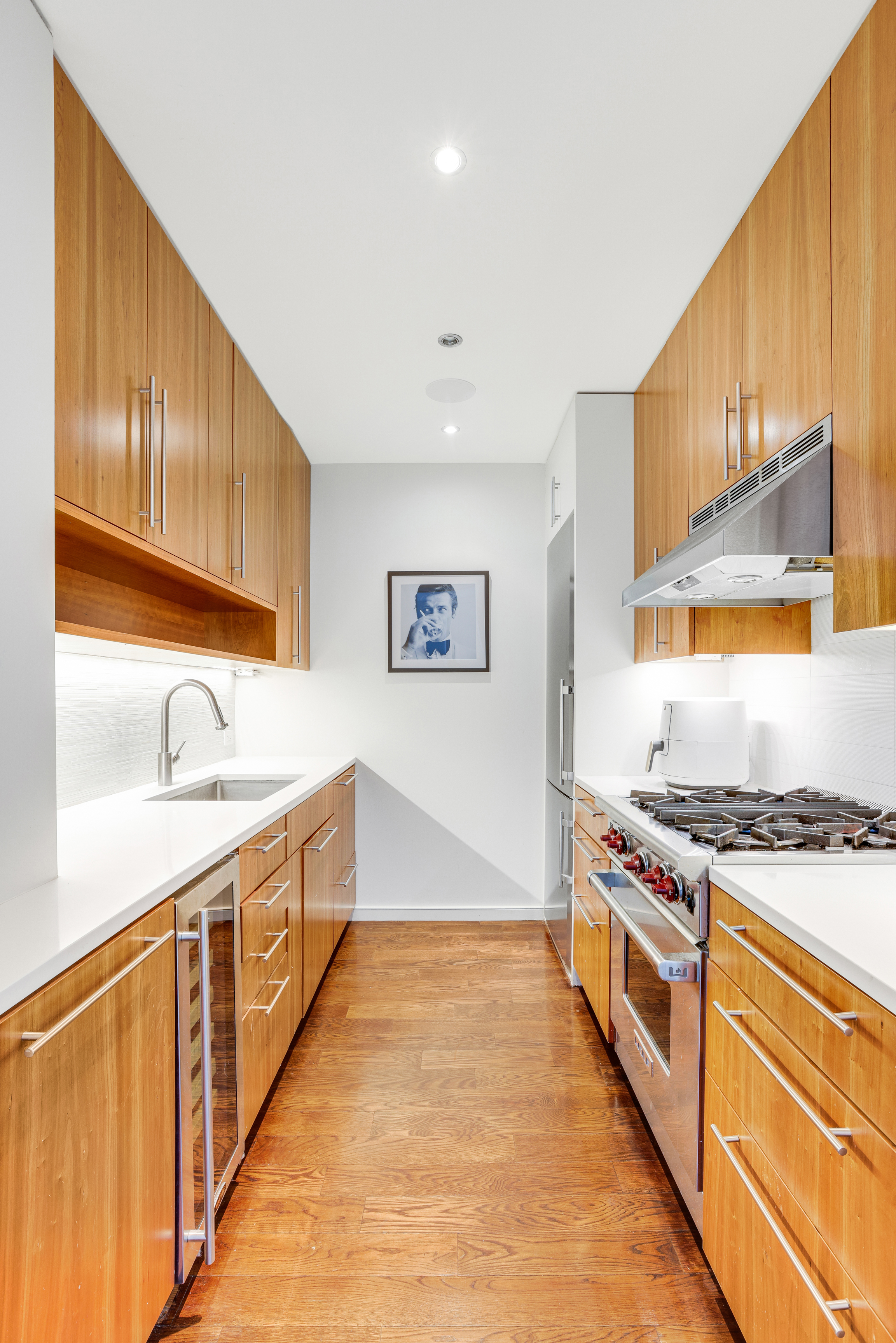 111 West 67th Street, Unit 34F Manhattan, NY 10023 - Photo 4 of 11 a kitchen with stainless steel appliances granite countertop a stove and a sink