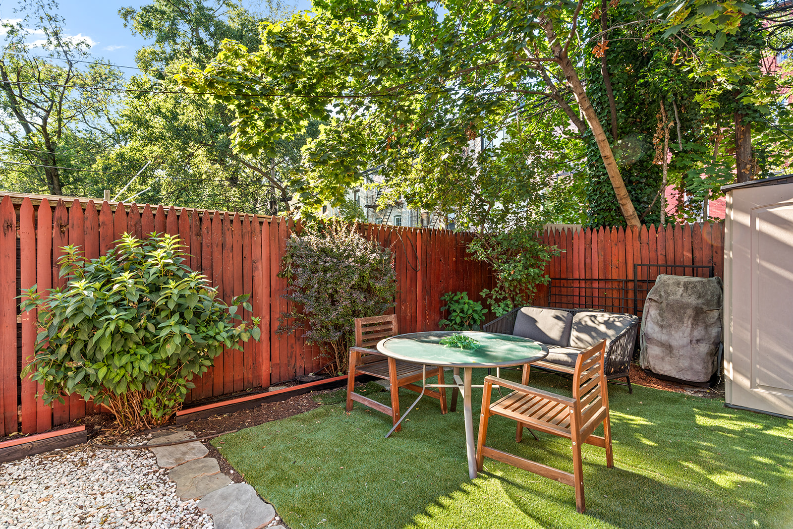 383 Bainbridge Street, Unit 1 Brooklyn, NY 11233 - Photo 4 of 14 a view of a chair and table in backyard