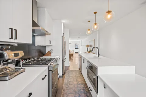 a kitchen with a sink and a stove top oven