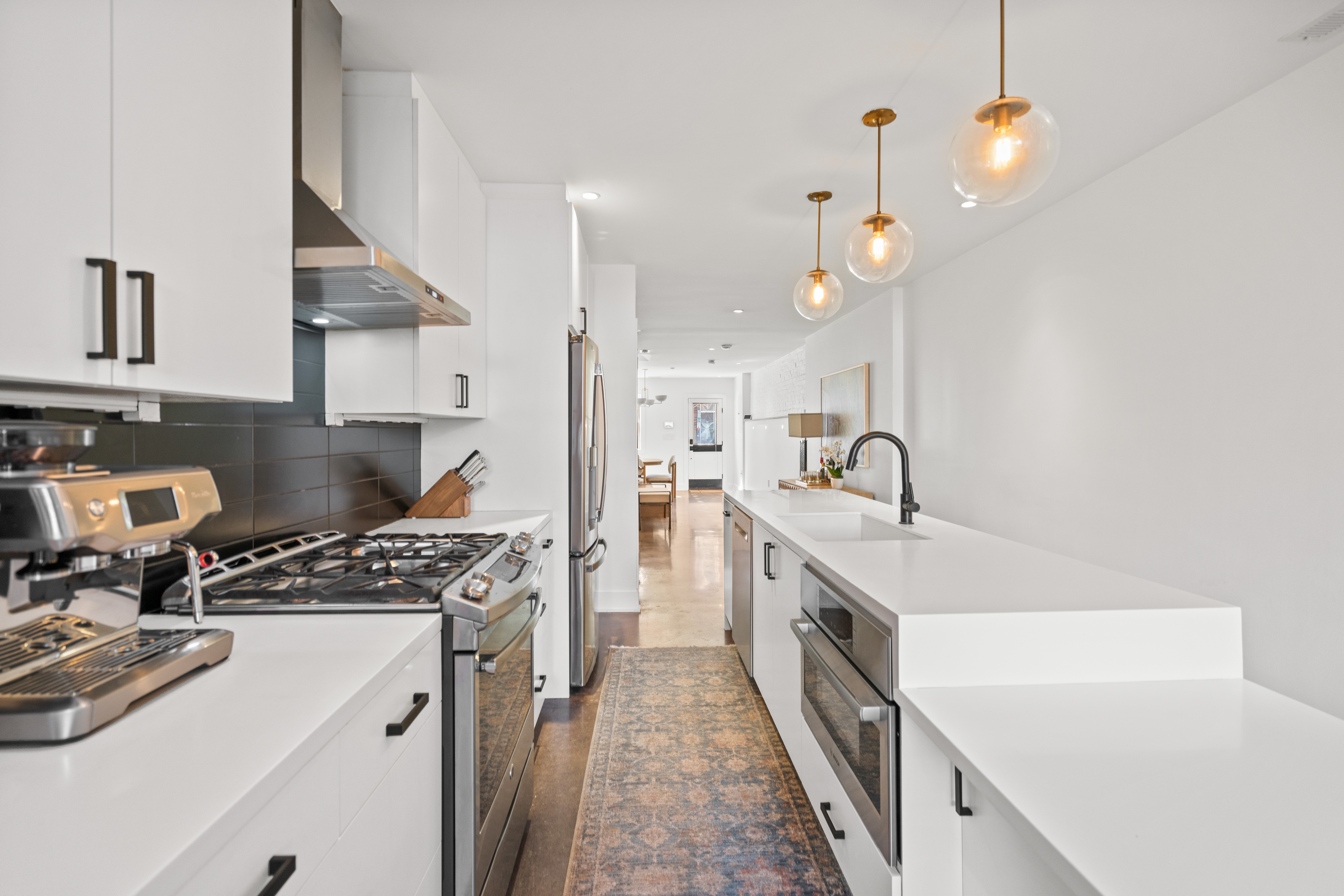 445 Ridge Street Northwest Washington, DC 20001 - Photo 13 of 43 a kitchen with a sink and a stove top oven