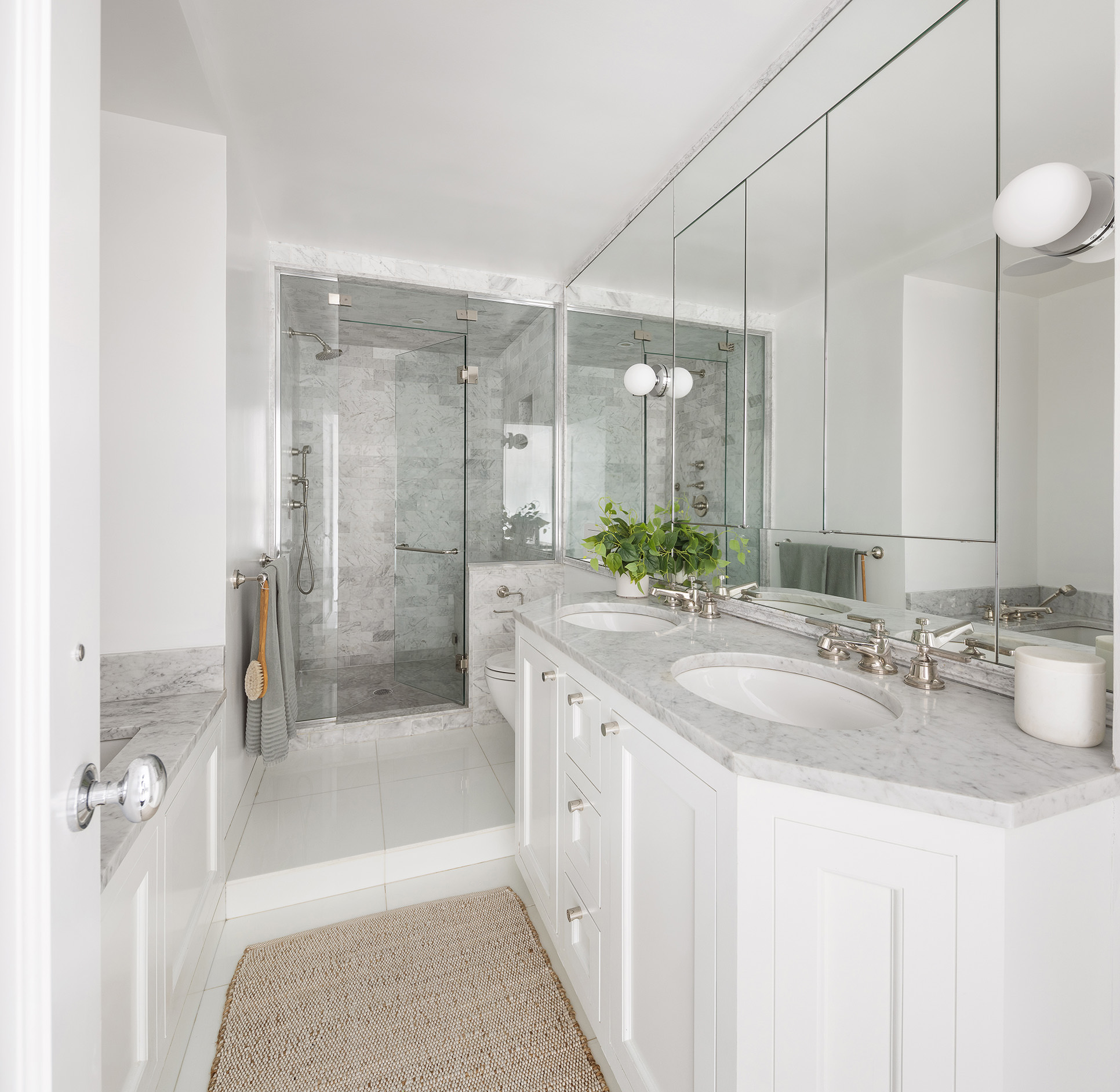 101 West 12th Street, Unit 8RS Manhattan, NY 10011 - Photo 10 of 19 a bathroom with a granite countertop sink mirror and a bath tub
