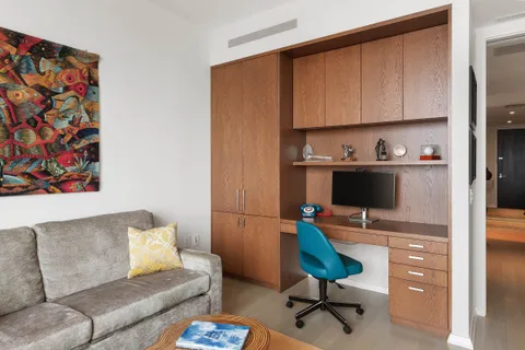 a bedroom with a bed and glass windows