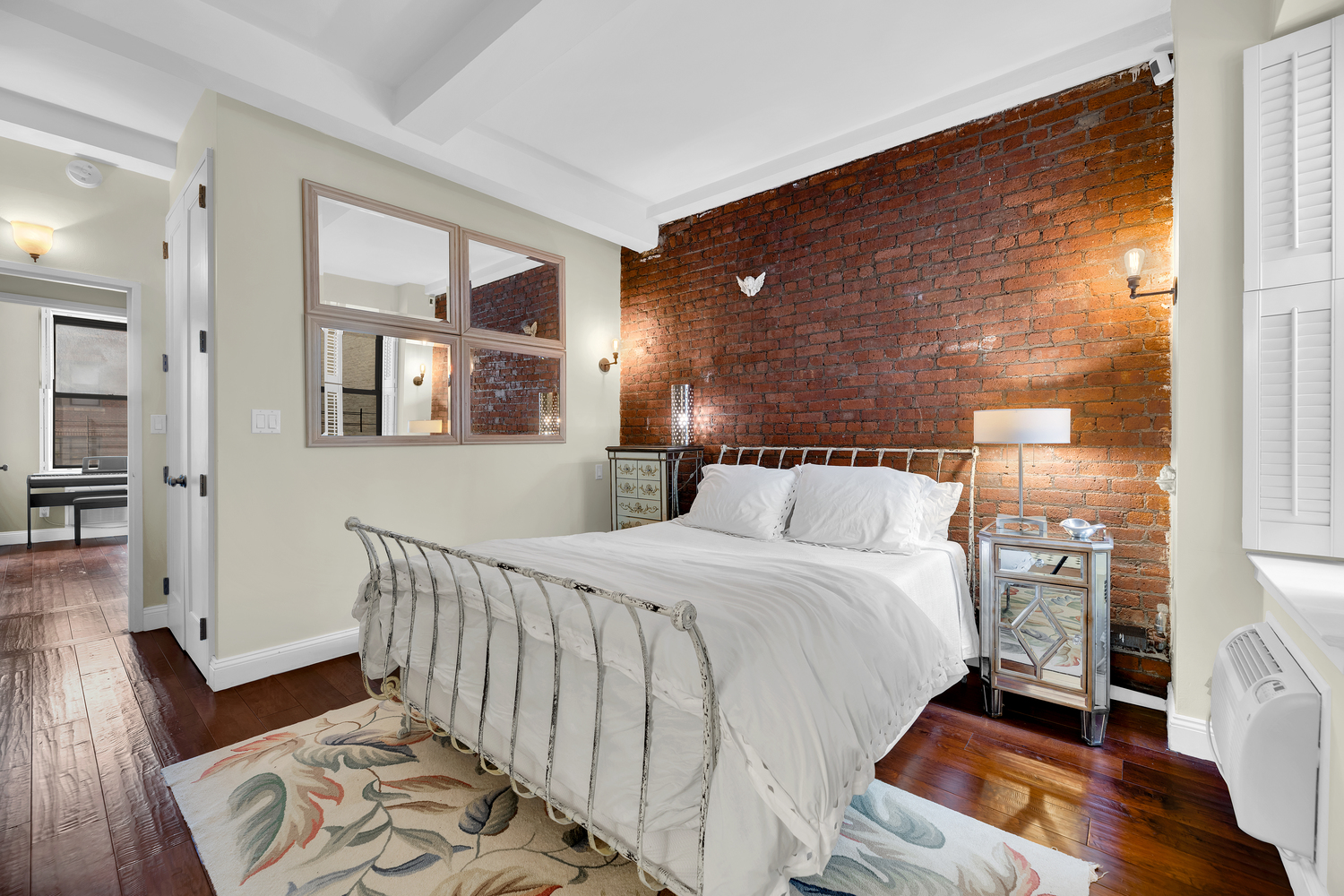 23 East 10th Street, Unit 321 Manhattan, NY 10003 - Photo 3 of 10 a bedroom with a bed and wooden floor
