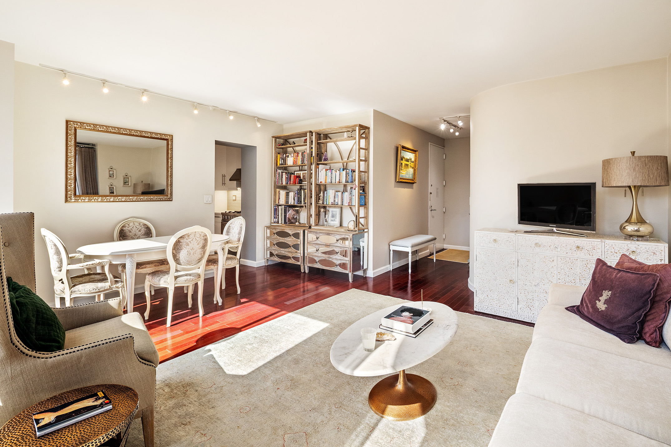 304 East 65th Street, Unit 10D Manhattan, NY 10065 - Photo 3 of 14 a living room with furniture and a flat screen tv