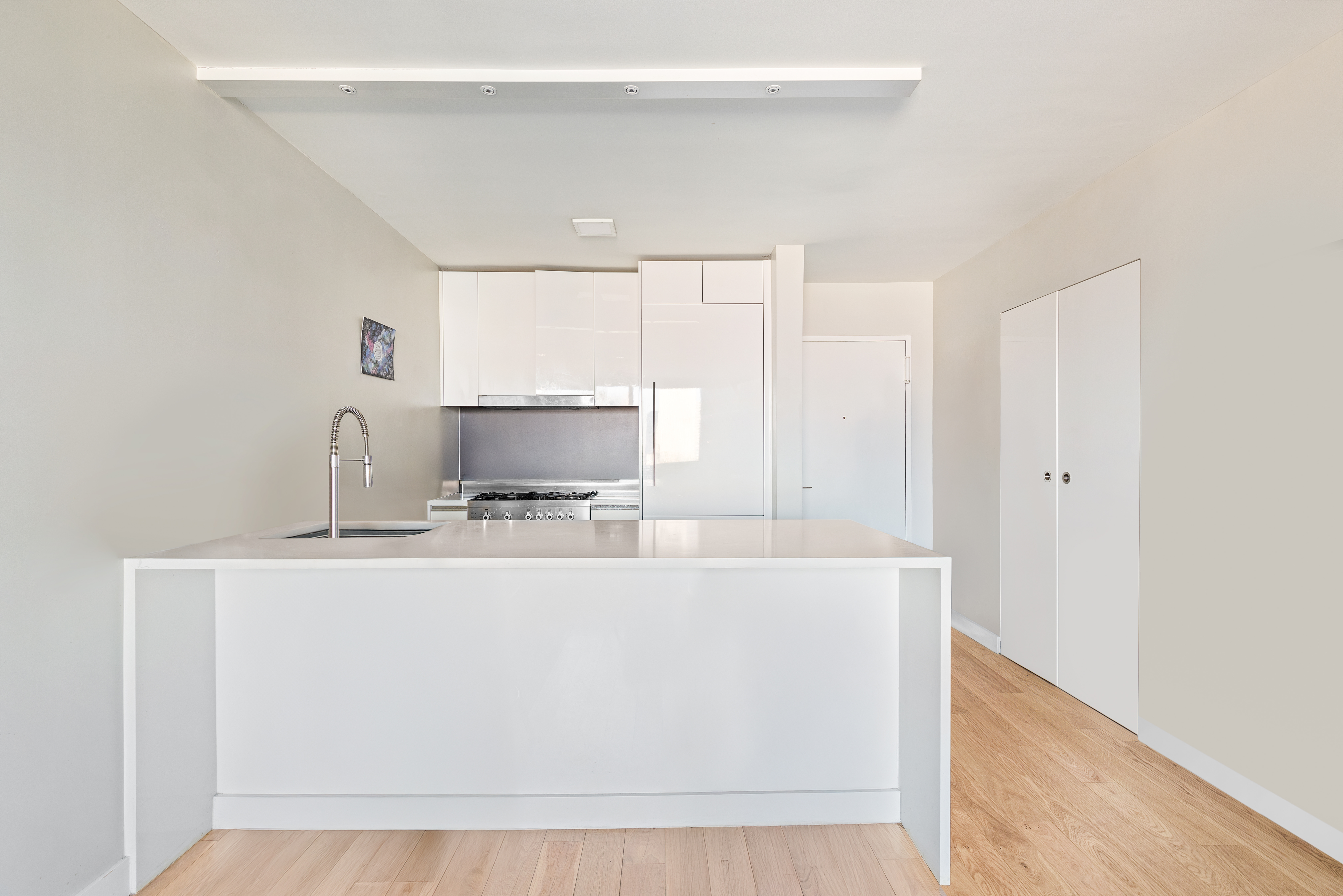 301 West 53rd Street, Unit 16D Manhattan, NY 10019 - Photo 7 of 16 a view of a kitchen with sink cabinets and appliances