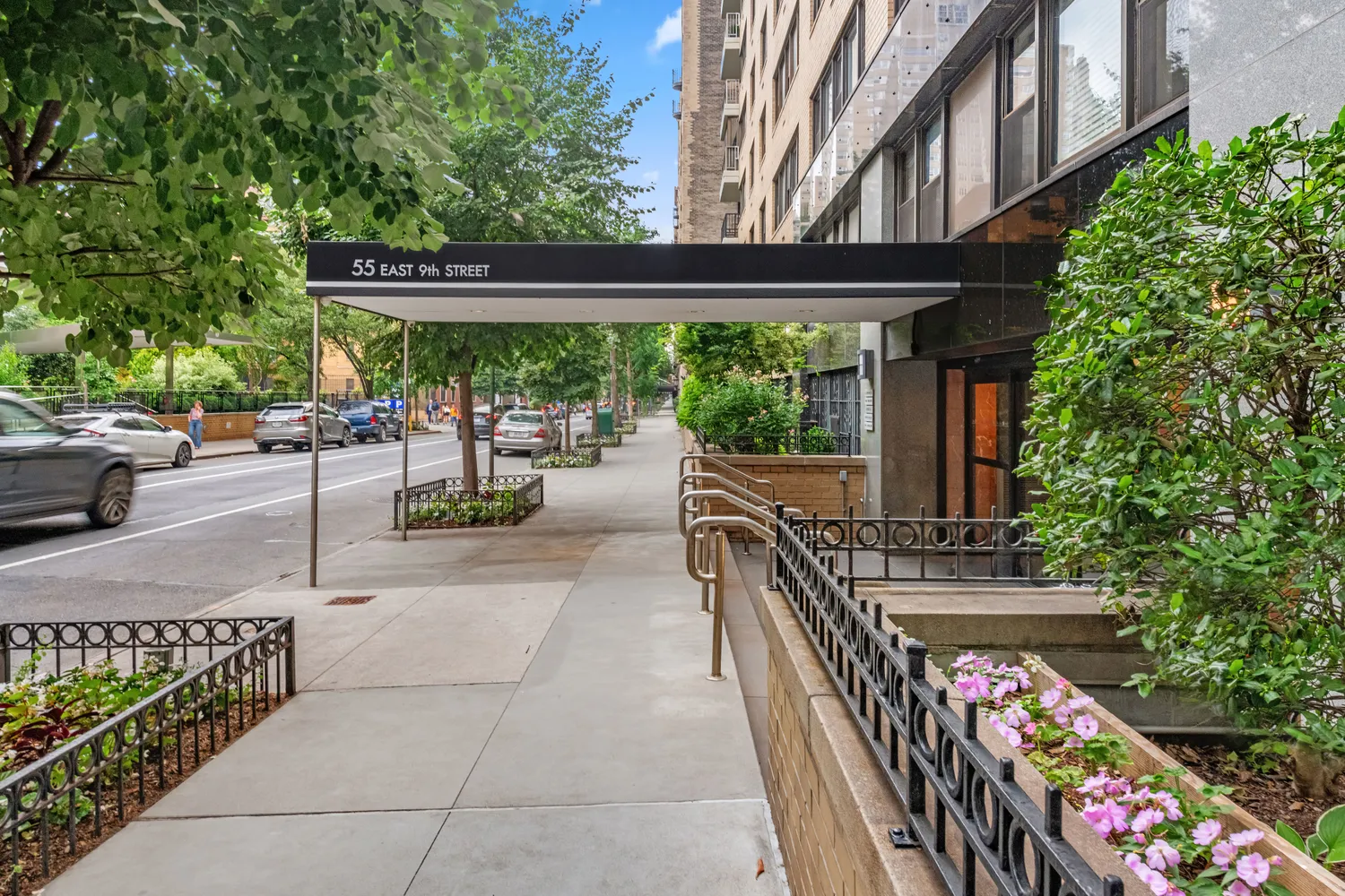 a view of a patio with table and chairs potted plants and floor to ceiling window