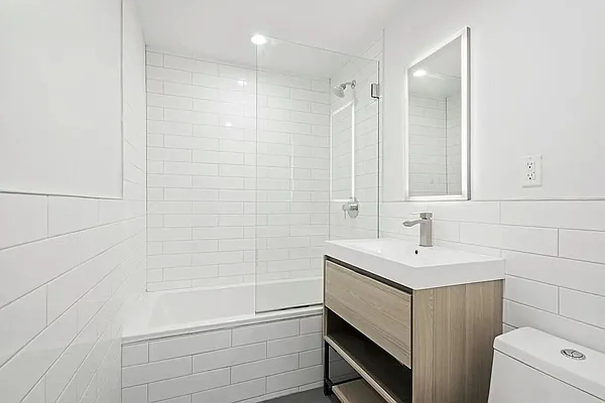 1316 Jefferson Avenue, Unit GDN Brooklyn, NY 11221 - Photo 5 of 6 a bathroom with a sink a toilet and shower