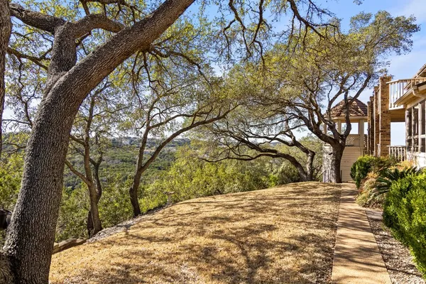 a view of yard with large trees