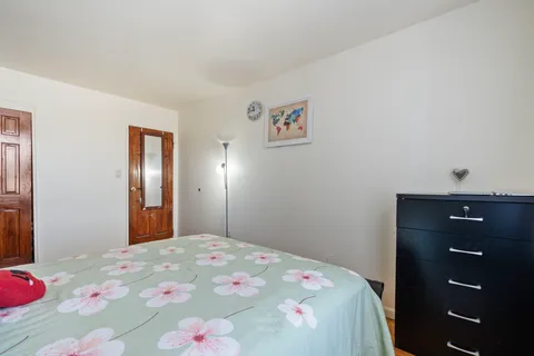 a bedroom with a bed and a dresser