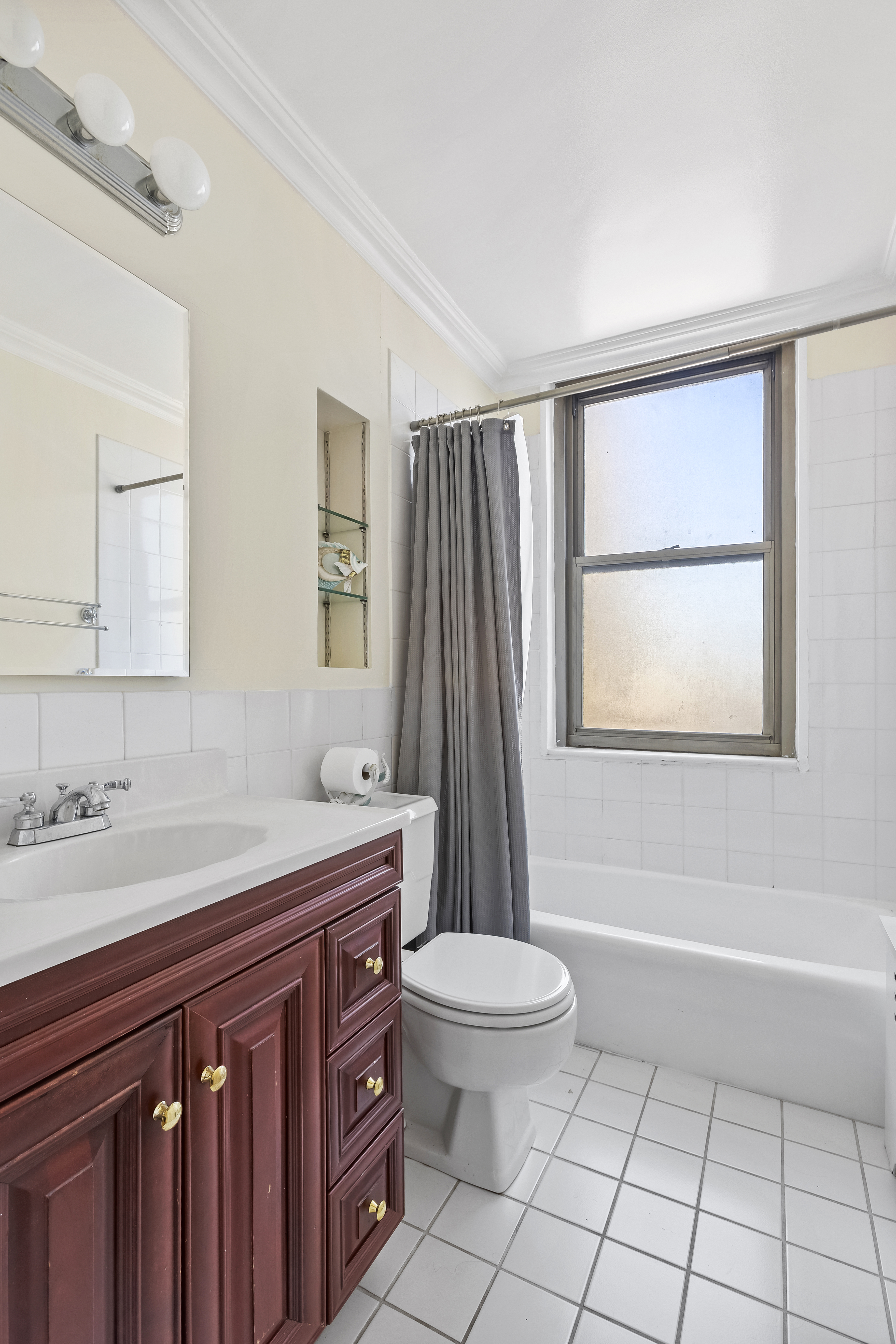 301 East 79th Street, Unit 31F Manhattan, NY 10075 - Photo 5 of 6 a bathroom with a sink a toilet and shower