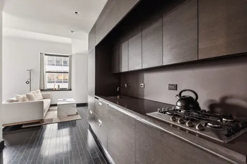 a kitchen with sink stove and cabinets