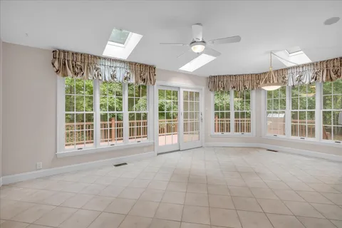 a view of an empty room with a fireplace and a window