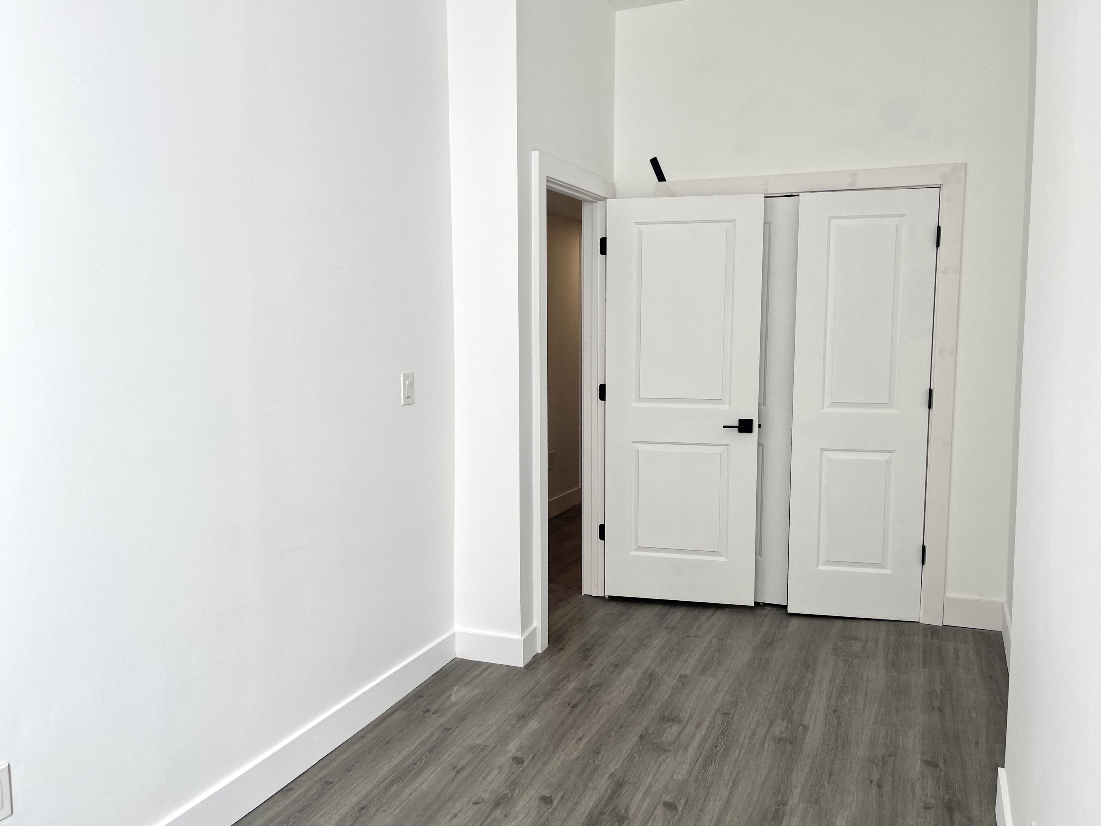 1999 3rd Avenue, Unit 1 Manhattan, NY 10029 - Photo 19 of 23 a view of an empty room with wooden floor
