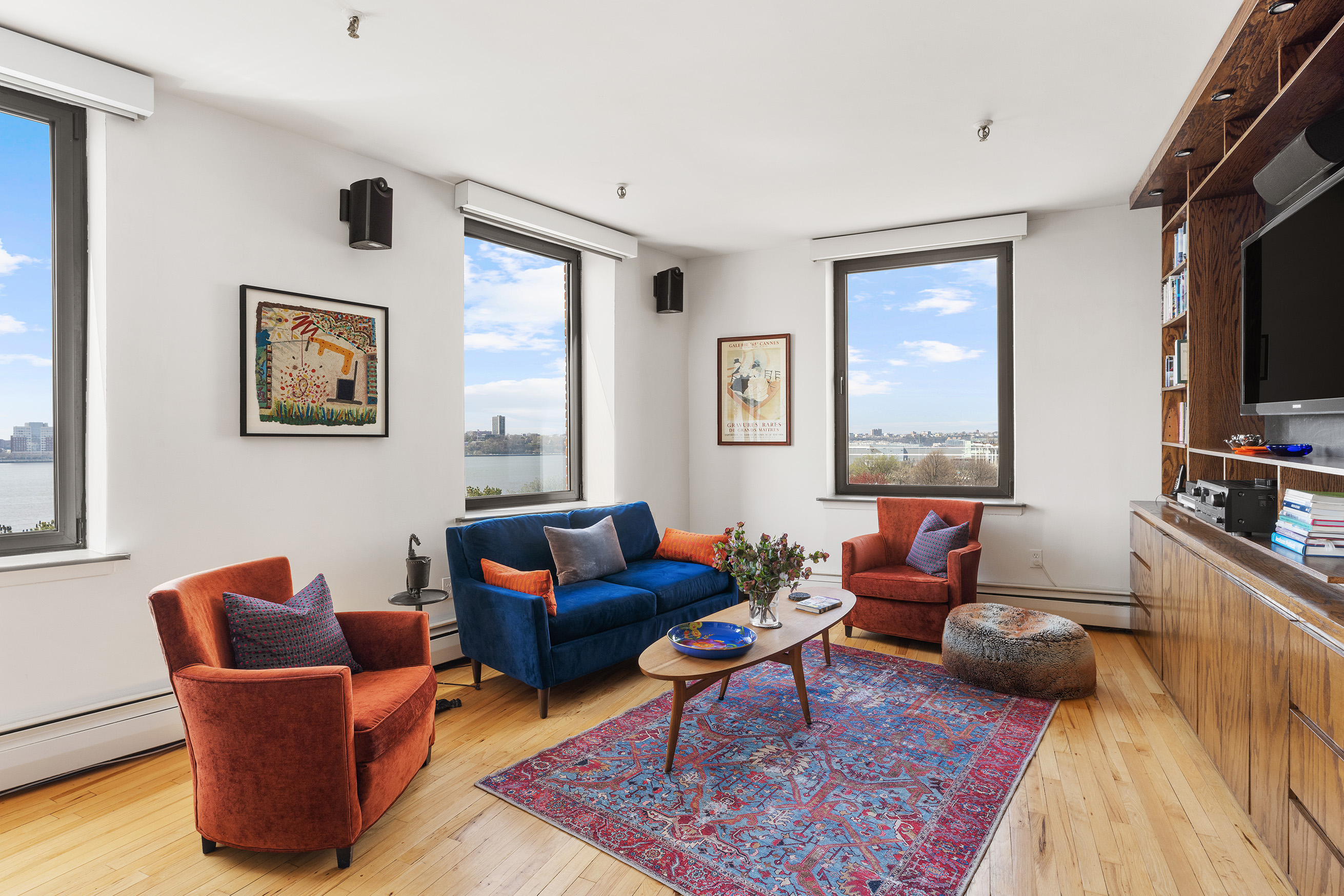 166 Bank Street, Unit 6B Manhattan, NY 10014 - Photo 3 of 16 a living room with furniture a rug and a flat screen tv