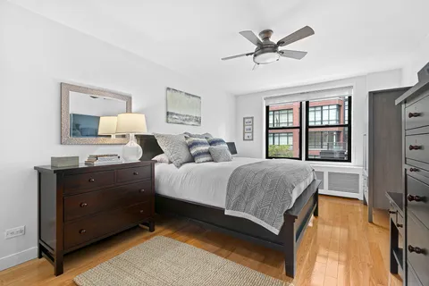 a bedroom with a large bed and a window