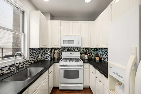 a kitchen with a sink stove and cabinets