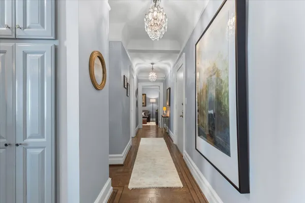 a bathroom with a granite countertop sink vanity mirror and toilet