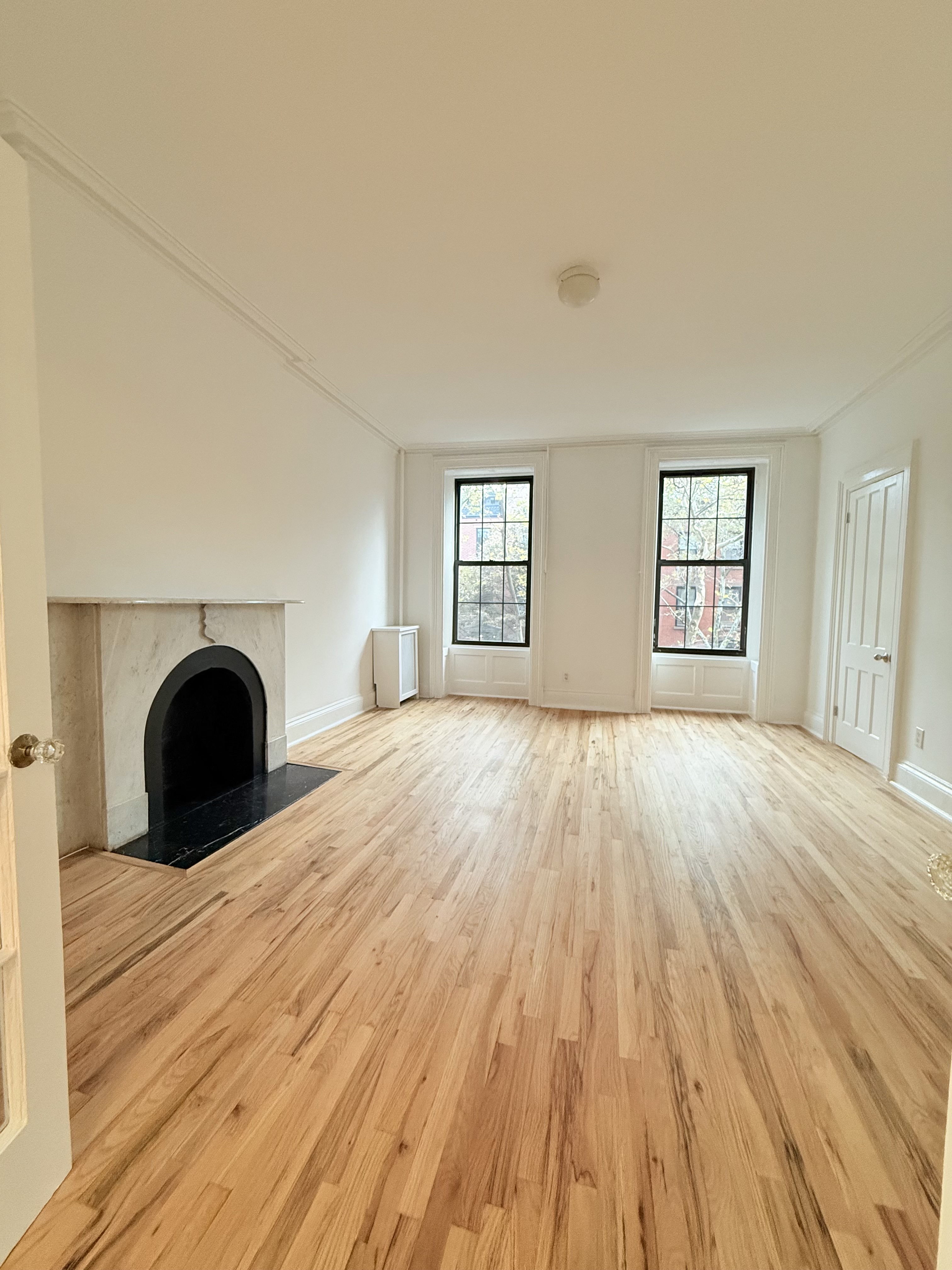 141 Summit Street, Unit 3 Brooklyn, NY 11231 - Photo 14 of 17 a view of a bedroom with wooden floor and window
