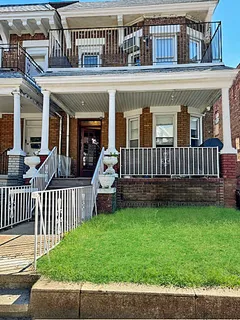 a view of a house with a yard and deck