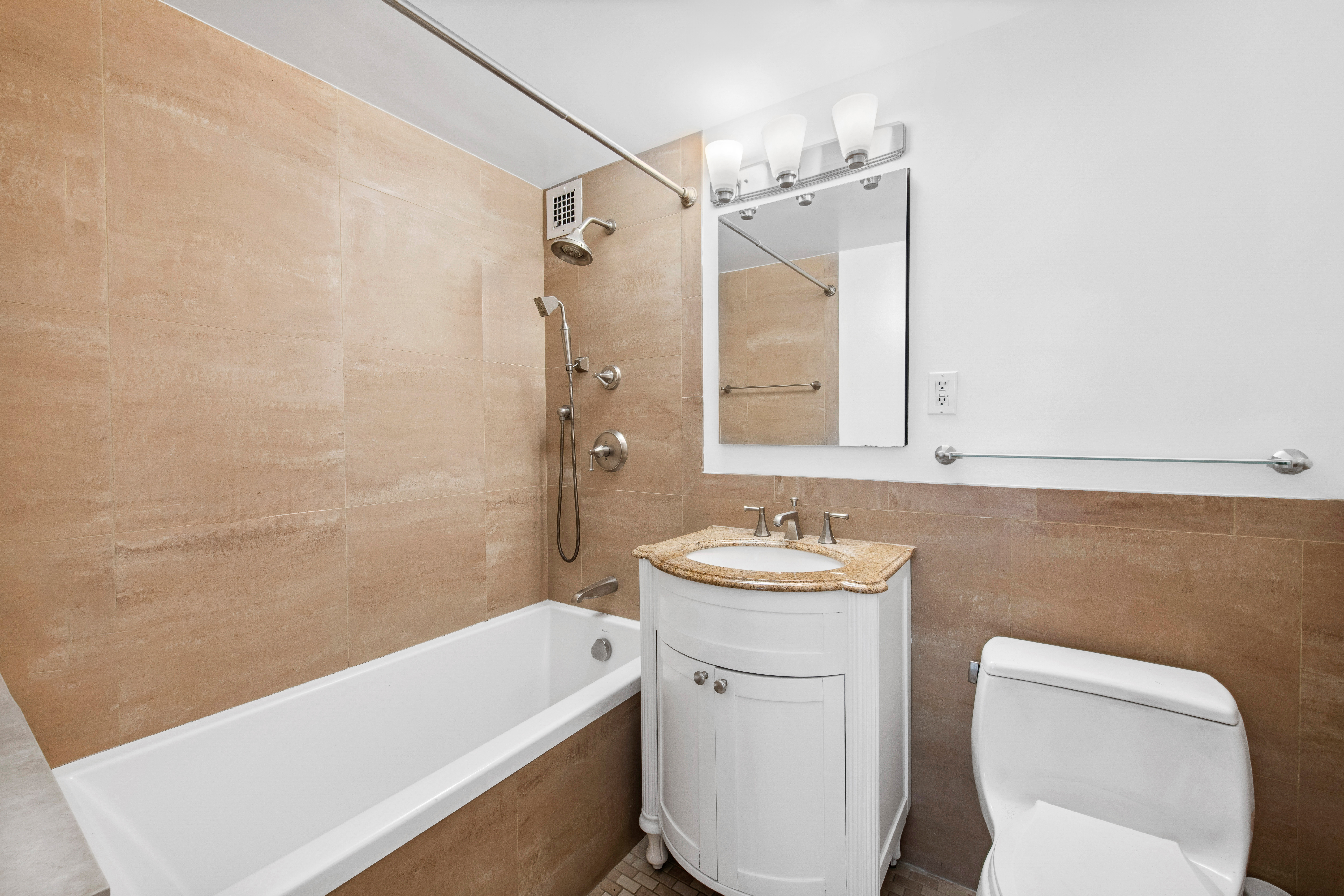201 East 62nd Street, Unit 2C Manhattan, NY 10065 - Photo 13 of 14 a bathroom with a sink a toilet and shower