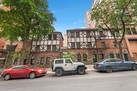 a view of cars parked in front of a house