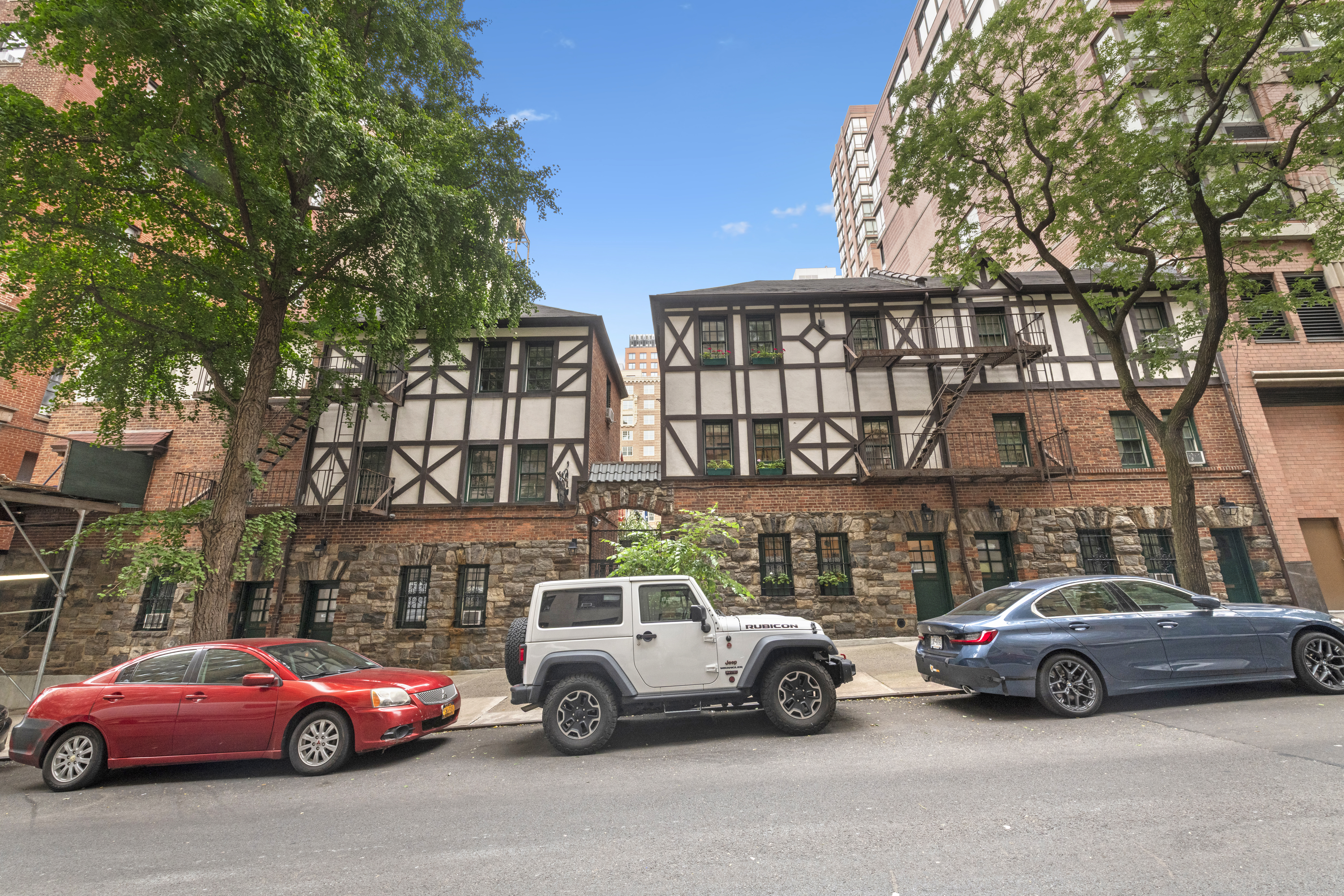10 Pomander Walk, Unit 1 Manhattan, NY 10025 - Photo 12 of 13 a view of cars parked in front of a house