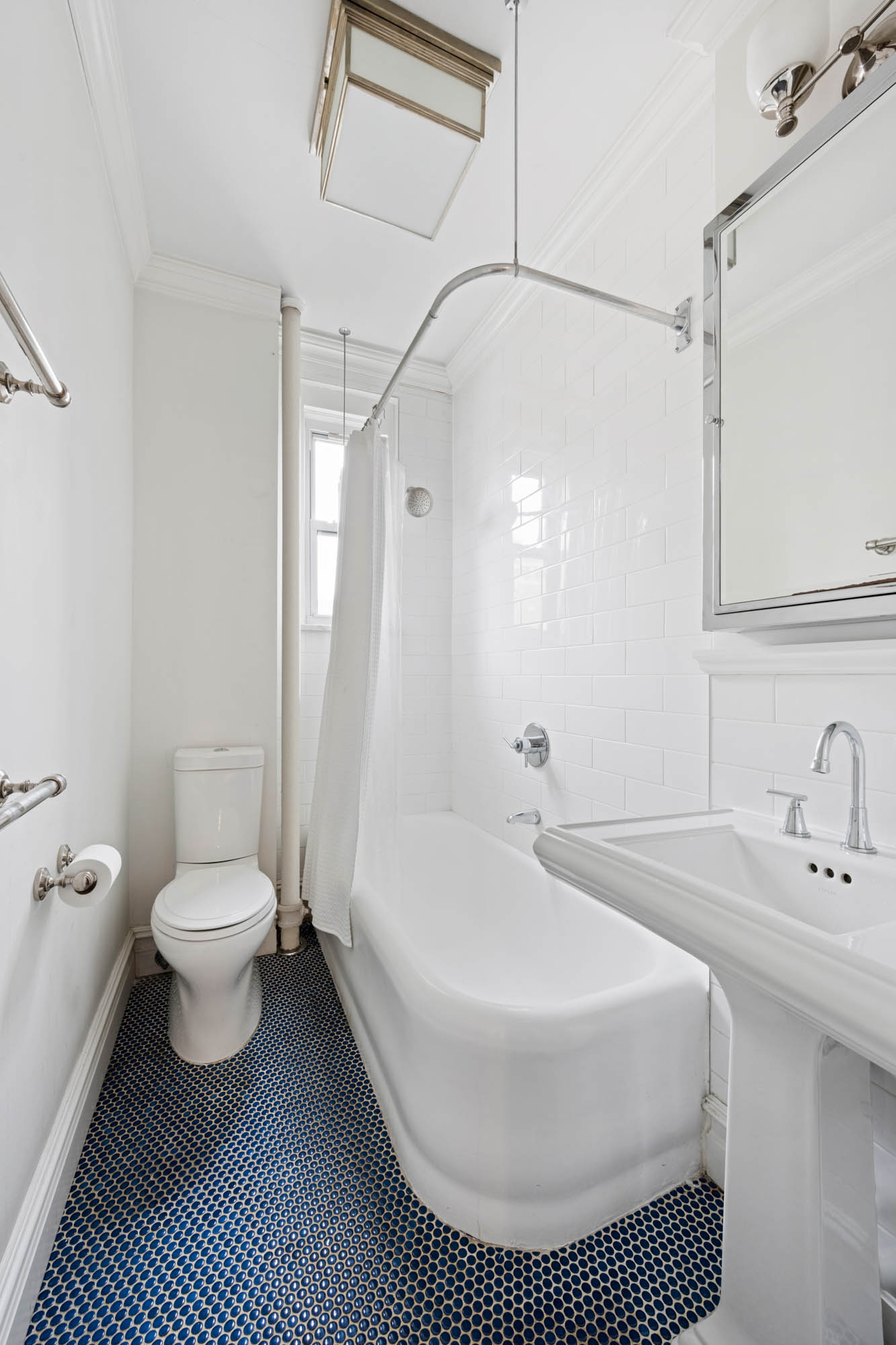 136 East 36th Street, Unit 9/10C Manhattan, NY 10016 - Photo 17 of 23 a bathroom with a sink a toilet and a bathtub