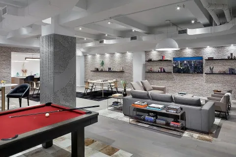 a living room with furniture and a pool table