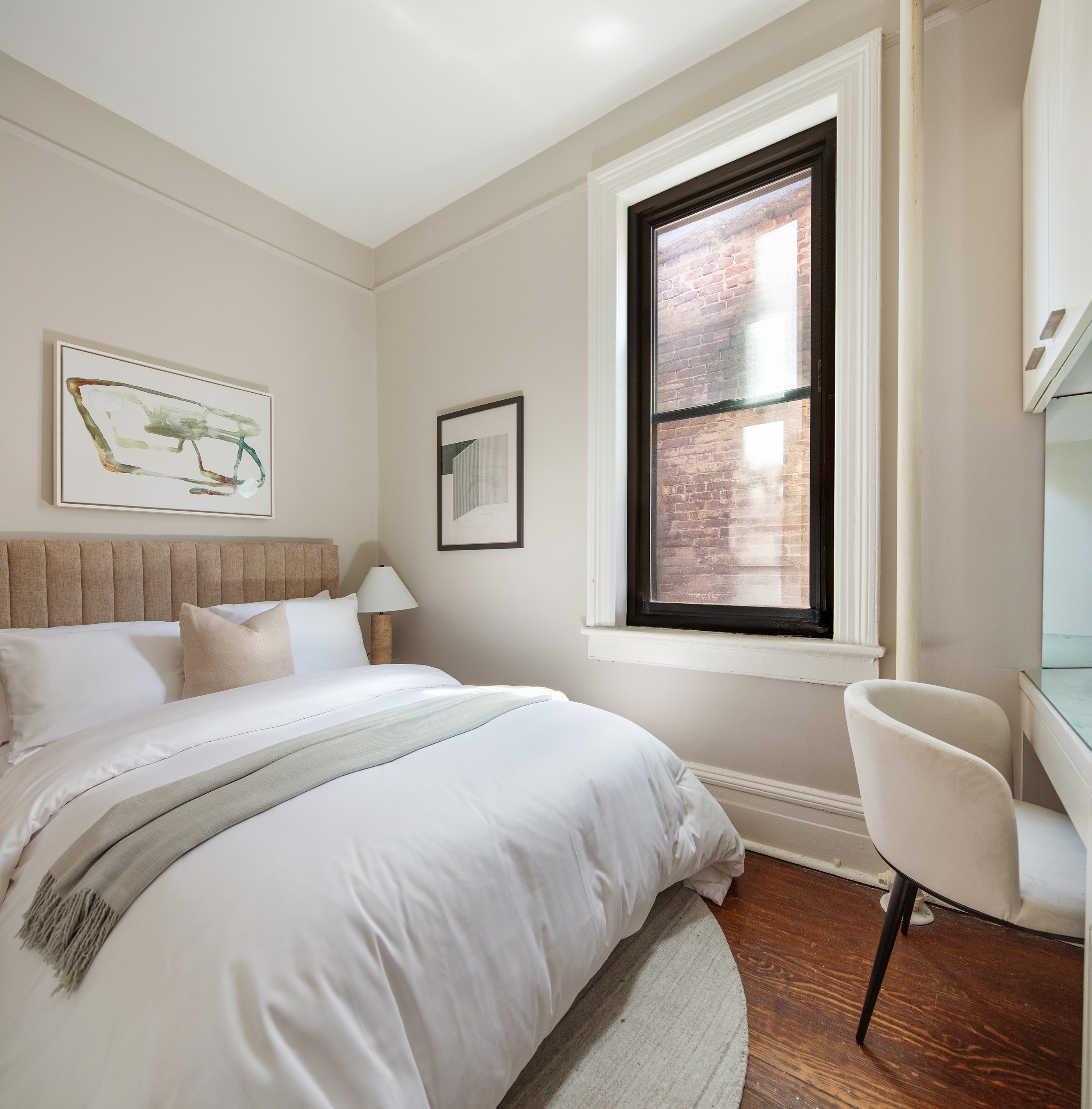 223 West 21st Street, Unit PH5M Manhattan, NY 10011 - Photo 7 of 12 a bedroom with a bed and a window