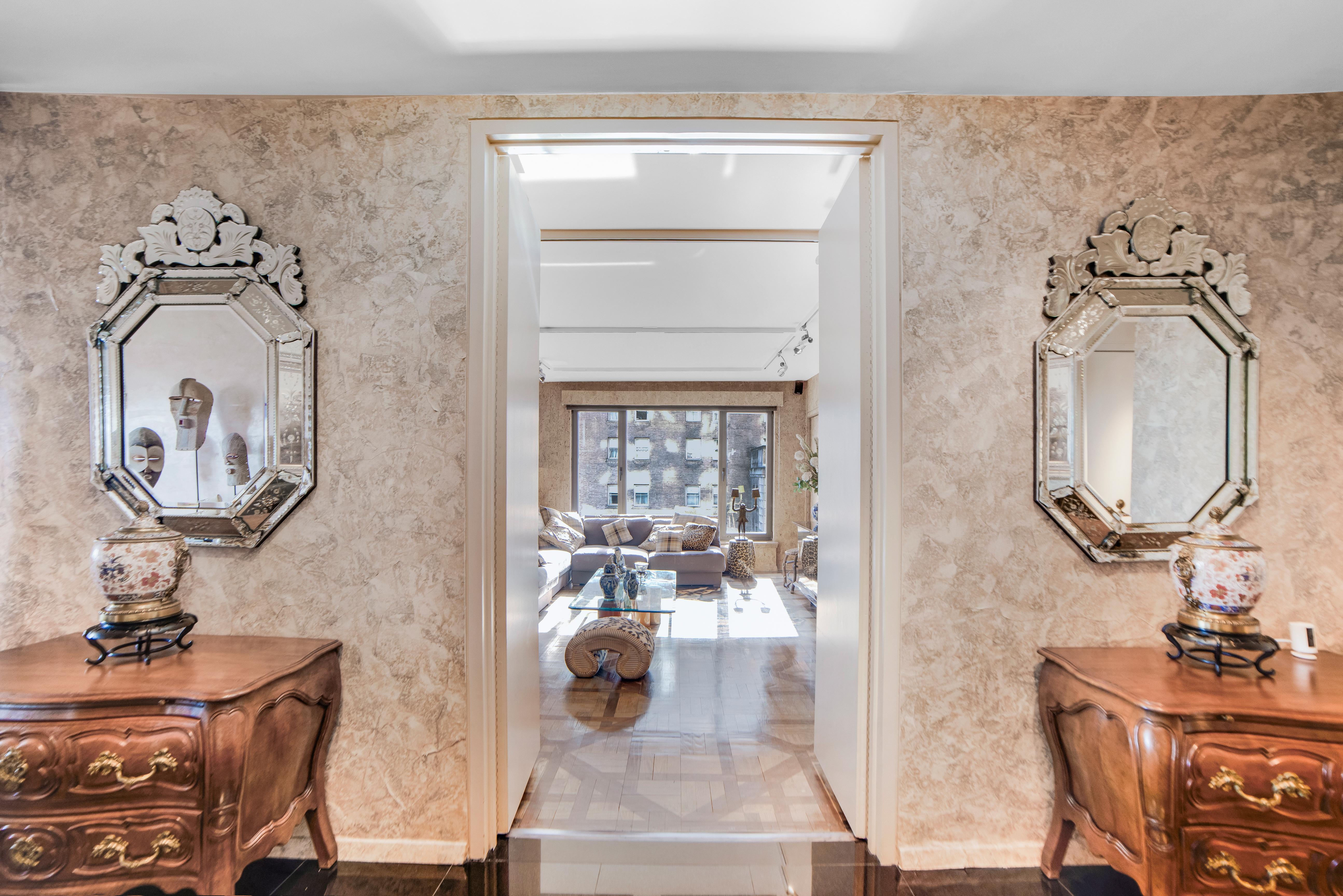 200 Central Park South, Unit 24A Manhattan, NY 10019 - Photo 11 of 23 a living room with furniture and a mirror