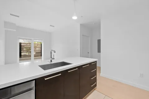 a room with a sink and cabinets