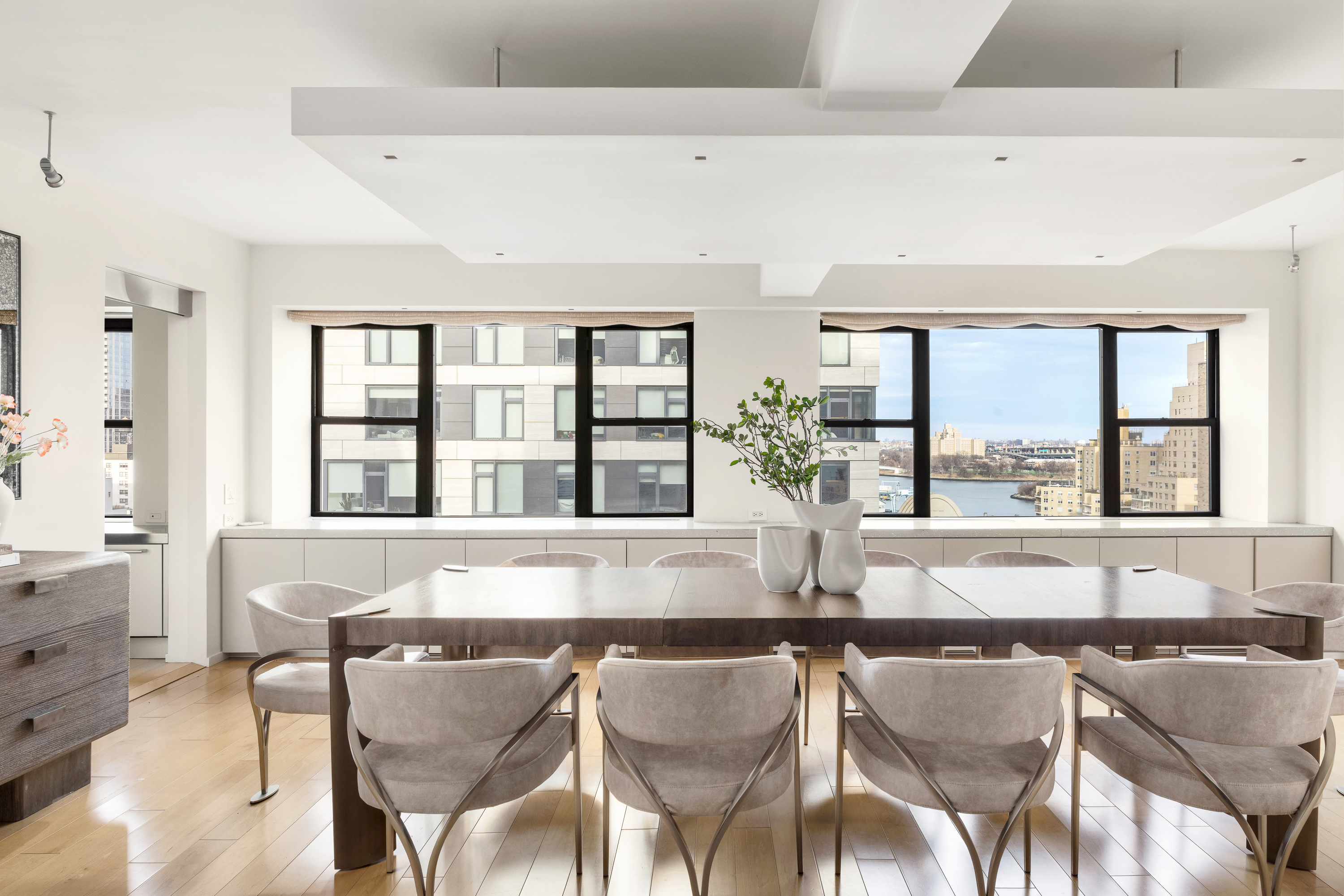 510 East 86th Street, Unit 17C Manhattan, NY 10028 - Photo 6 of 31 a view of a dining room with furniture and large windows