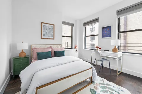 a bed room with a bed and a window