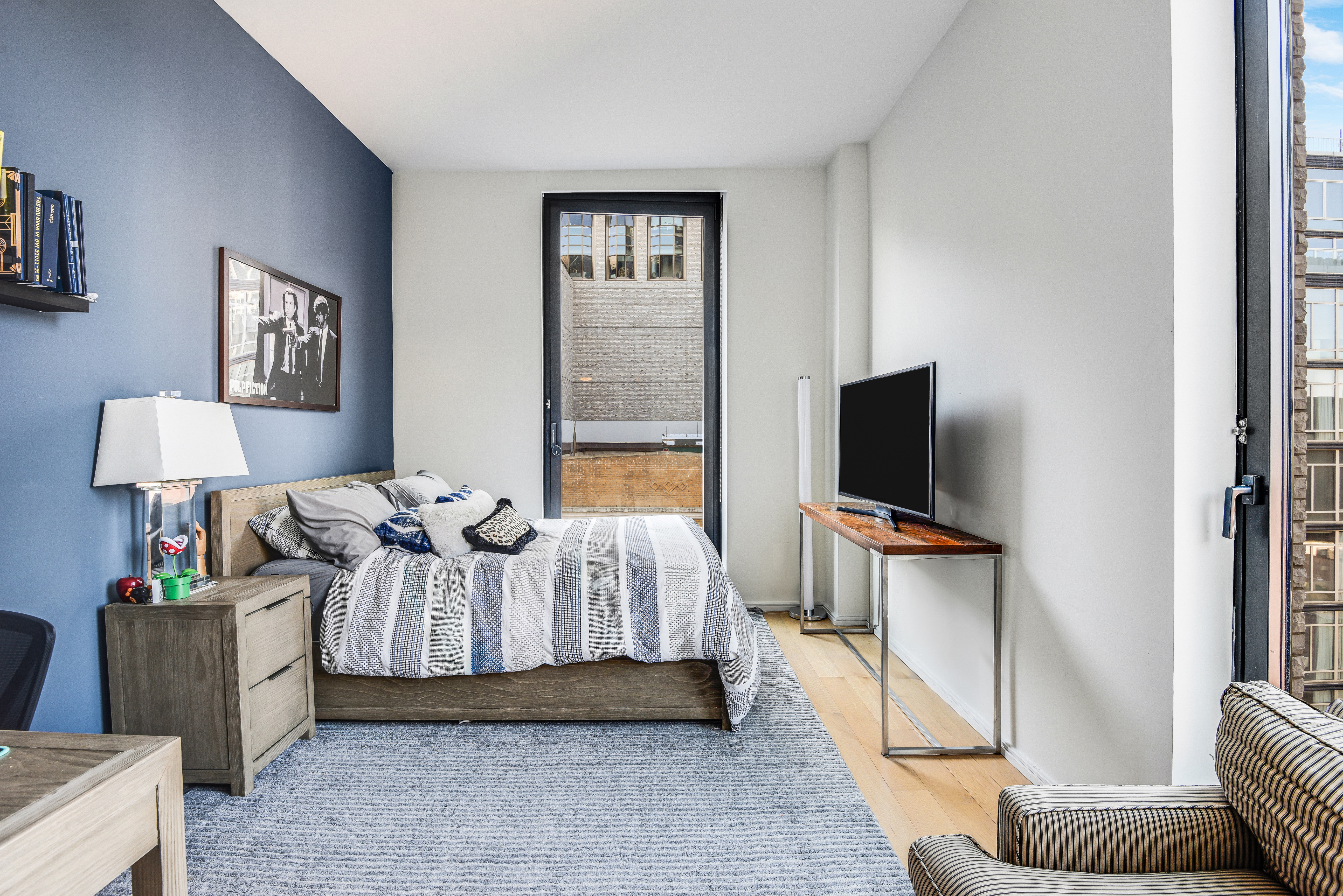 505 West 19th Street, Unit 7W Manhattan, NY 10011 - Photo 21 of 31 a bedroom with a bed and a flat screen television