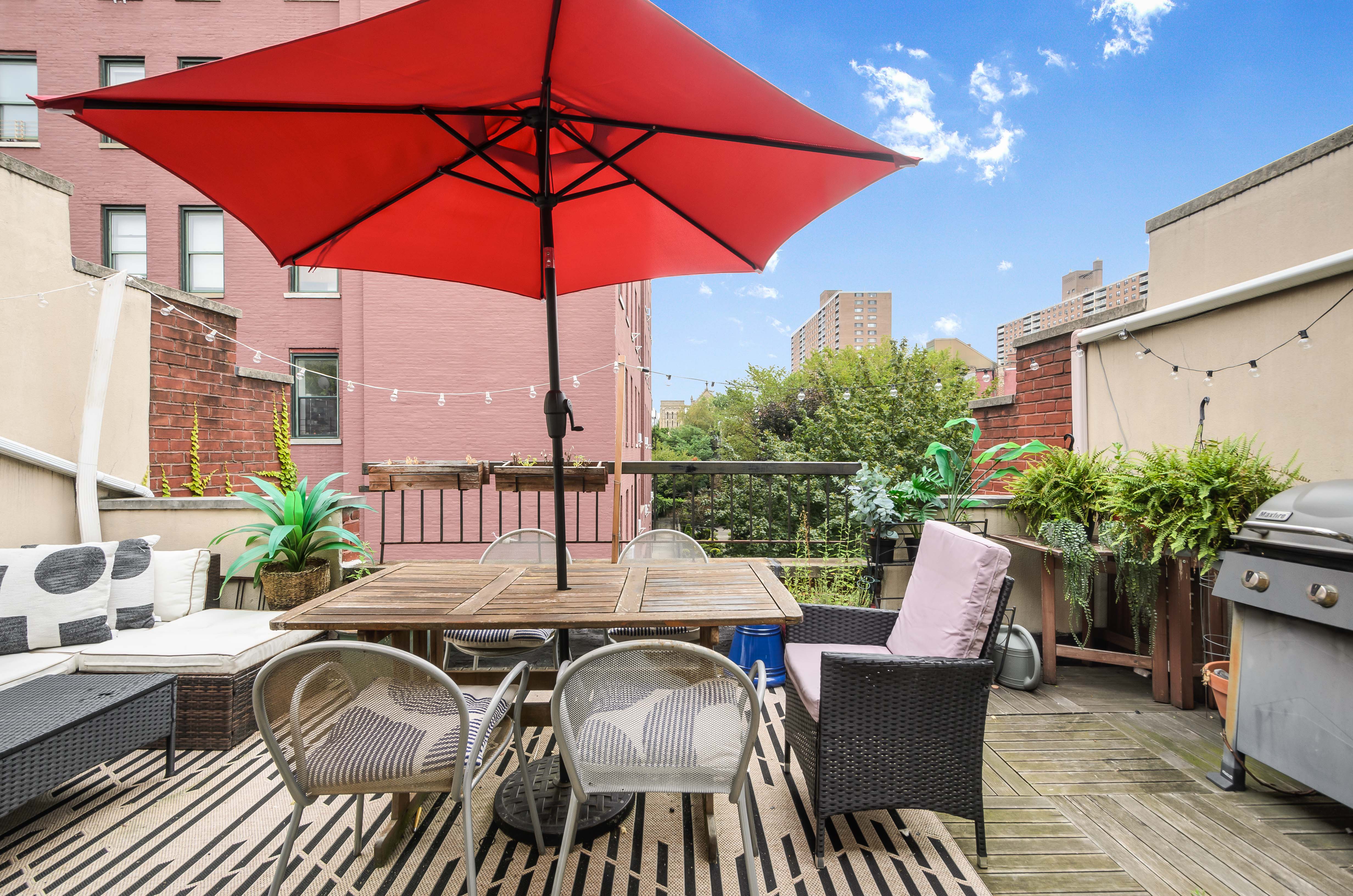 173 Greene Avenue, Unit 2 Brooklyn, NY 11238 - Photo 7 of 12 a view of a patio with furniture and table under an umbrella