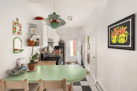 a dining room with table and chairs