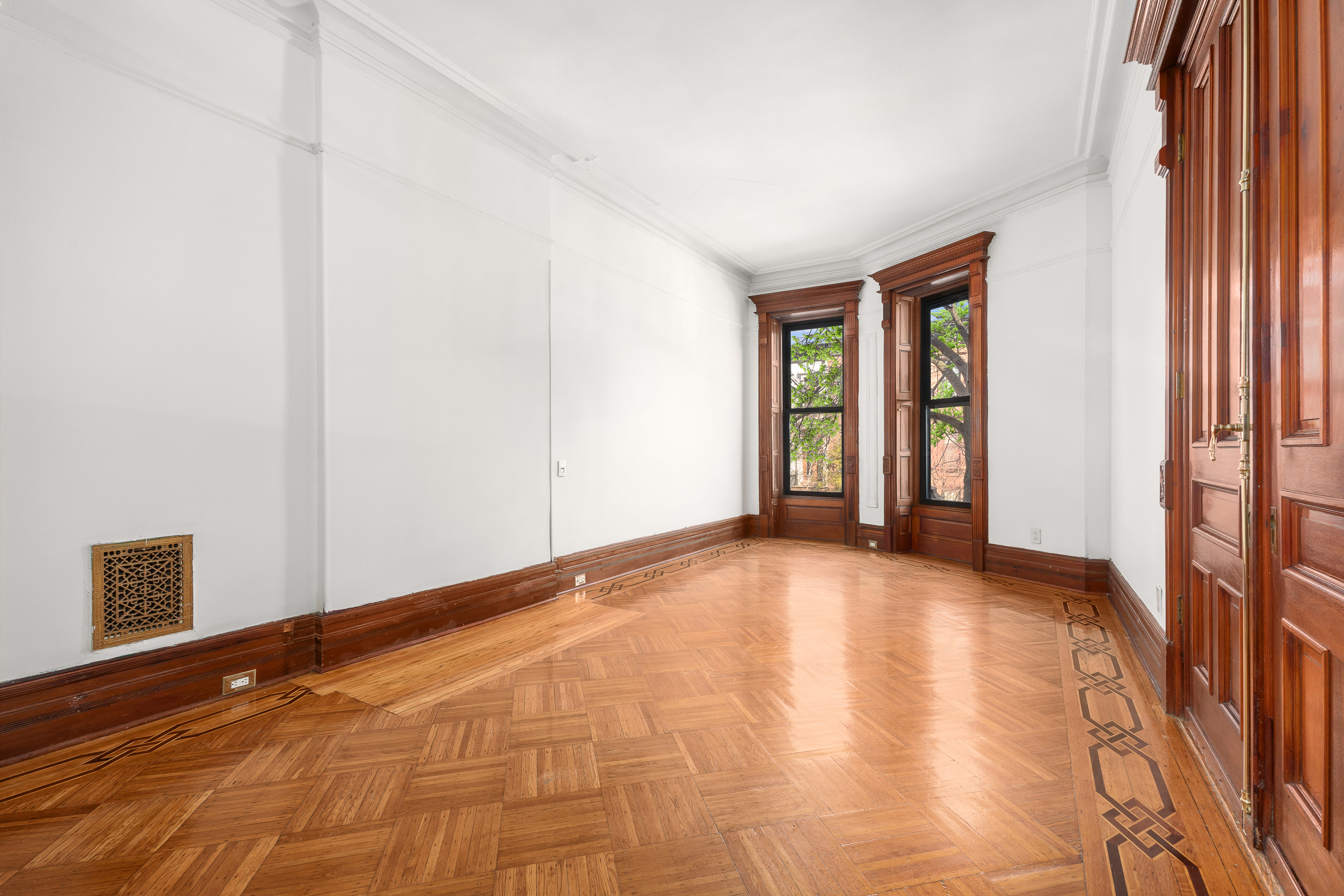 420 8th Street Brooklyn, NY 11215 - Photo 2 of 20 a view of an empty room with wooden floor and a window