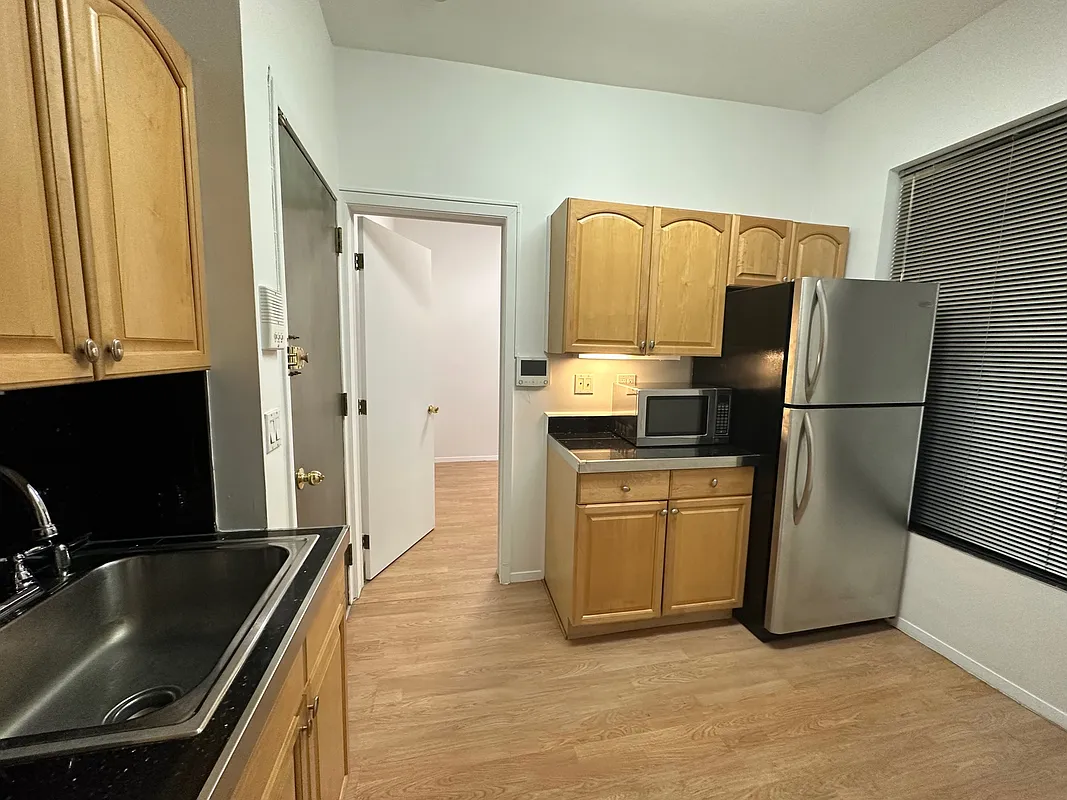 1315 3rd Avenue, Unit 4A Manhattan, NY 10021 - Photo 3 of 5 a kitchen with a refrigerator and a sink
