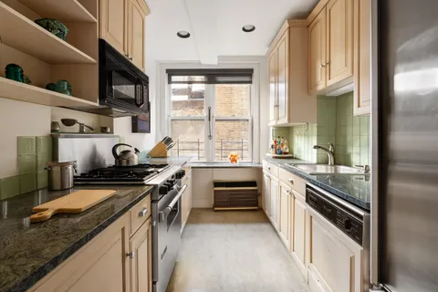 a kitchen with stainless steel appliances granite countertop a stove and a sink