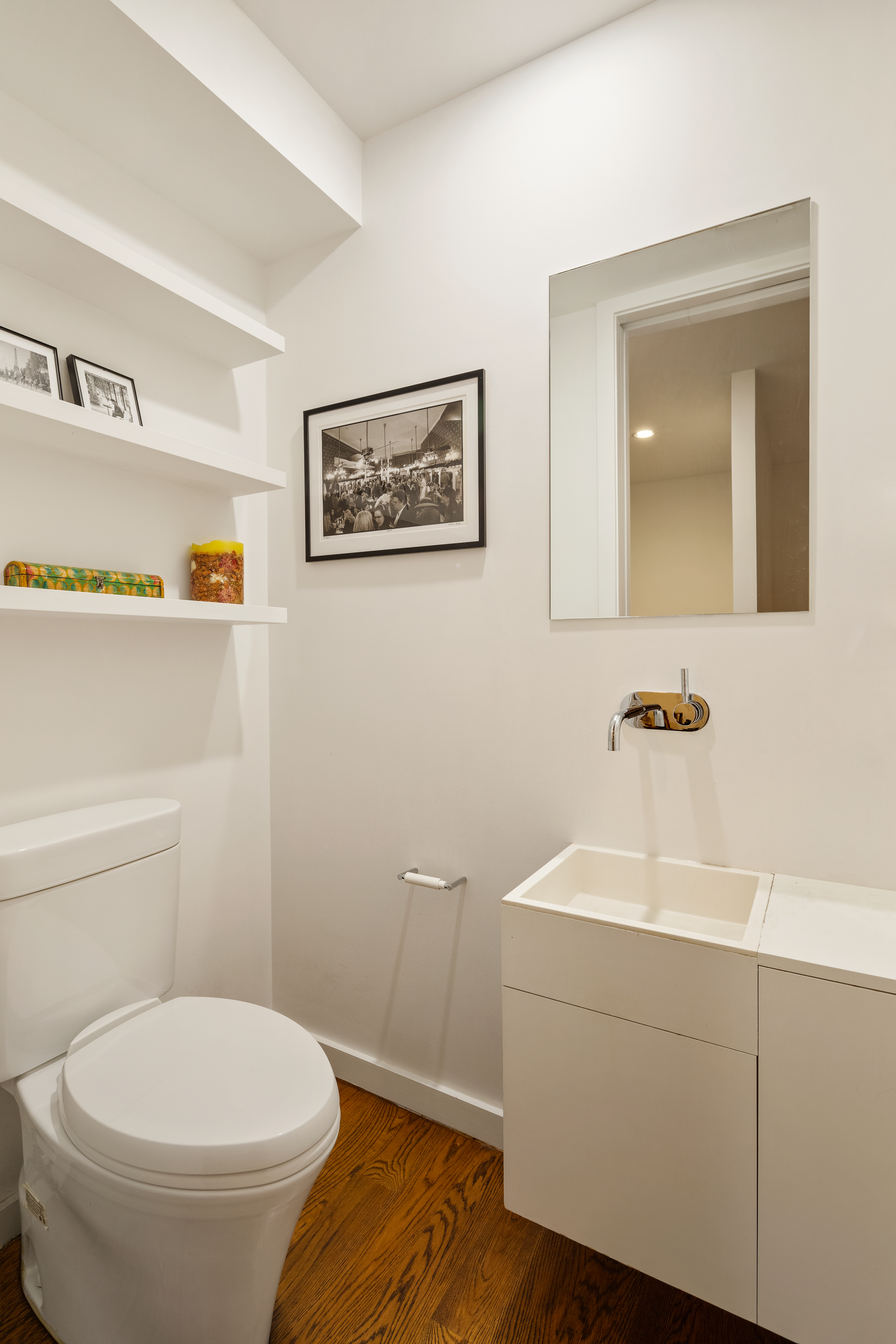 181 Sullivan Street, Unit GARDEN Manhattan, NY 10012 - Photo 7 of 10 a bathroom with a toilet sink and mirror