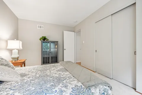 a bedroom with a bed and a lamp