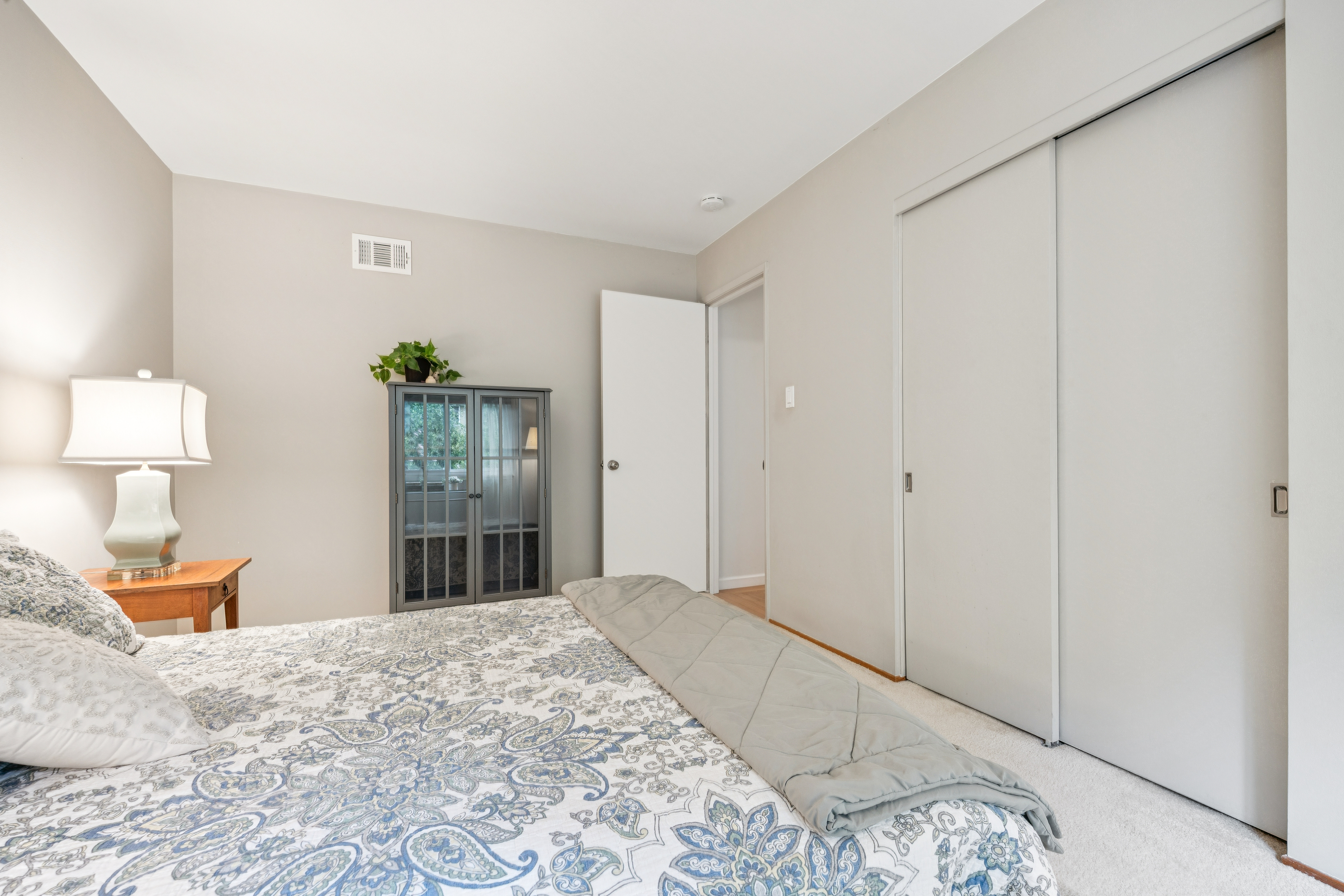 77 Bothin Road Fairfax, CA 94930 - Photo 20 of 32 a bedroom with a bed and a lamp