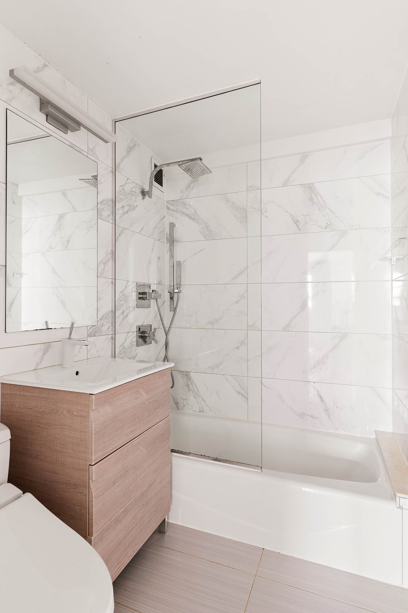 135 East 54th Street, Unit 6M Manhattan, NY 10022 - Photo 7 of 10 a bathroom with a bathtub and a shower