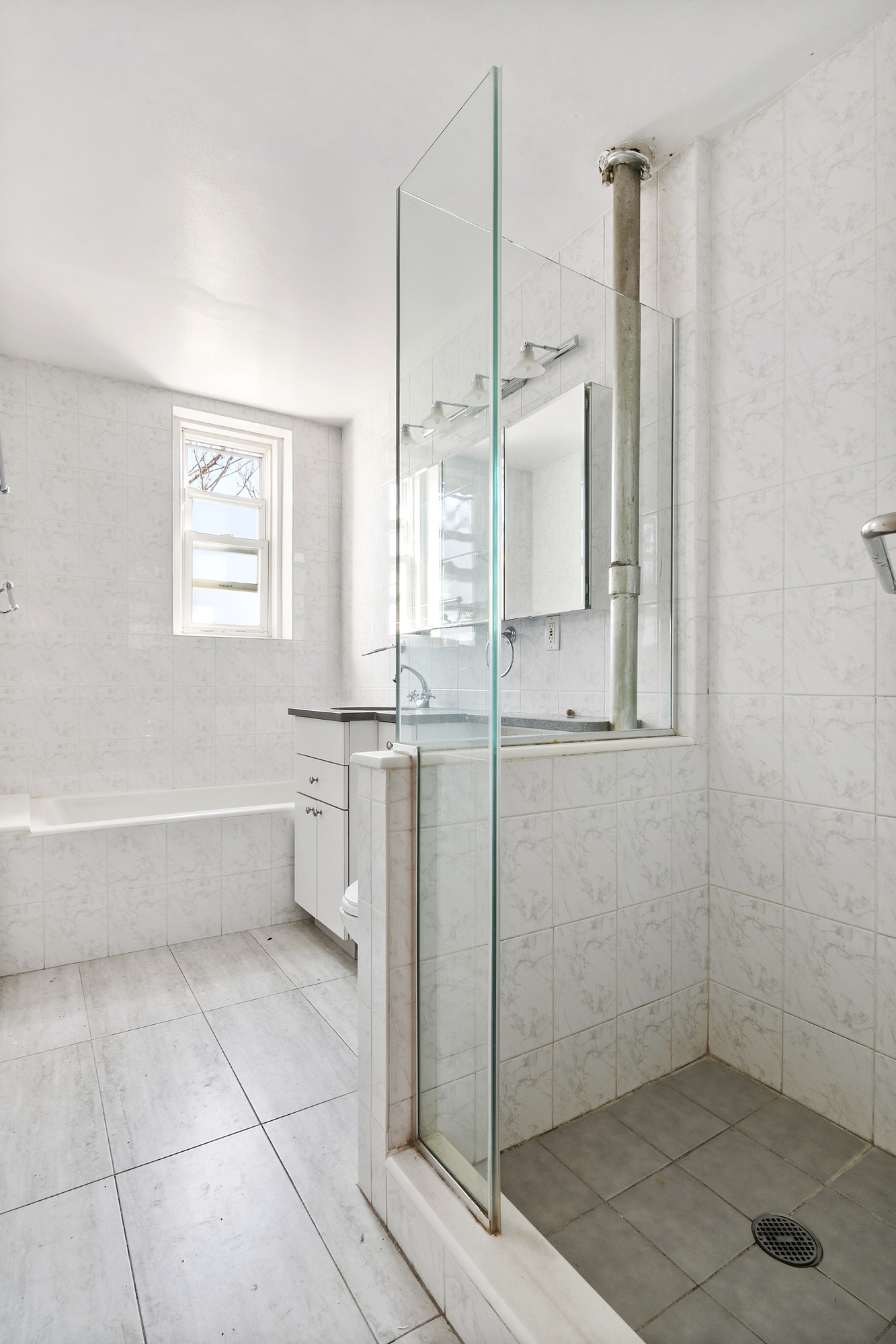 1615 Avenue I, Unit 603 Brooklyn, NY 11230 - Photo 10 of 13 a bathroom with a bathtub and a shower
