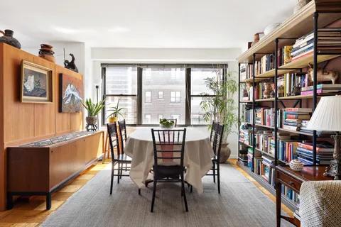 a view of a livingroom with furniture window and wooden floor