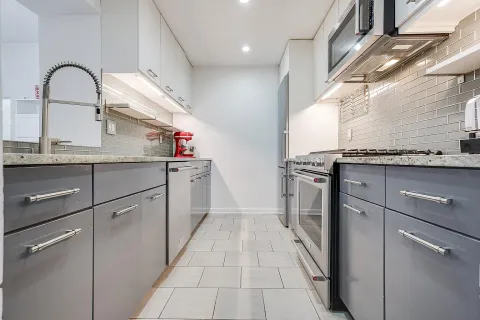 a kitchen with a sink and cabinets
