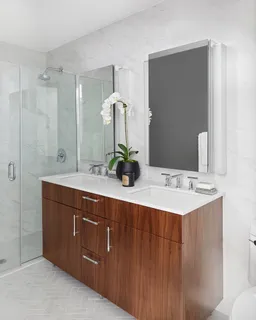 a bathroom with a double vanity sink and mirror