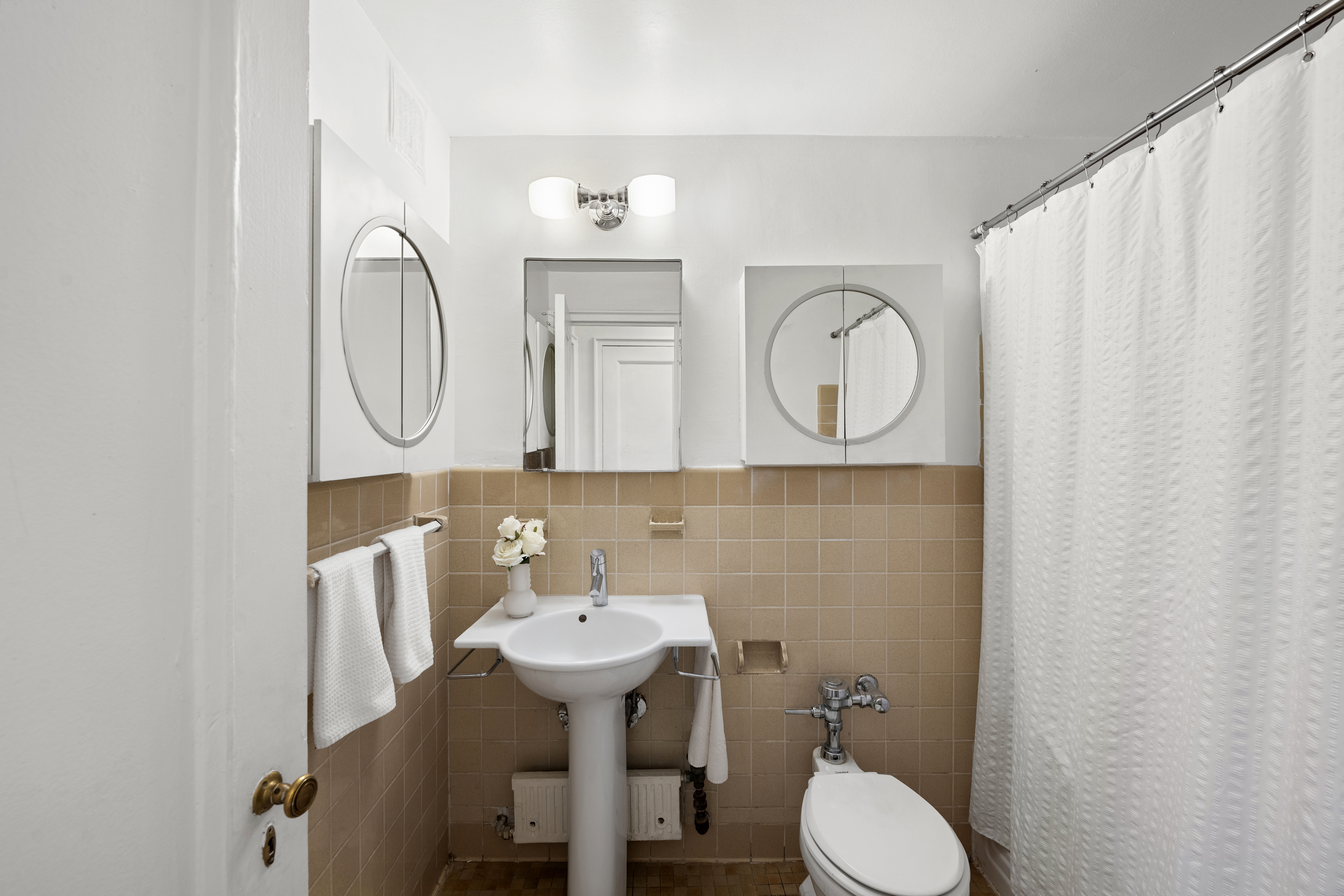 140 Riverside Drive, Unit 1G Manhattan, NY 10024 - Photo 11 of 16 a bathroom with a toilet sink and mirror